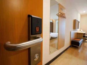 a door with a safe in a room at 7 Days Premium Qingdao Keji Street Taishan Road Metro Station in Qingdao +105 photos