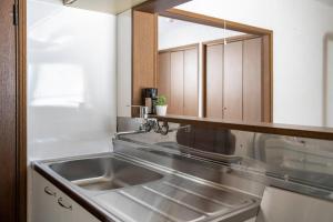 a kitchen with a sink and a mirror at Kotonoha in Otaru +77 photos
