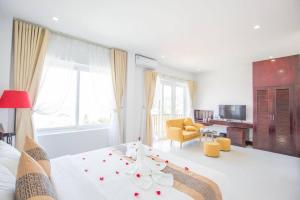 a bedroom with a bed and a living room at Sea Mountain Hotel in Vung Tau
