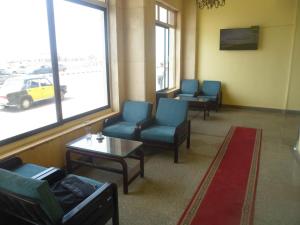 a waiting room with chairs and a table and a window at Royal Crown Hotel عائلات فقط in Alexandria +23 photos