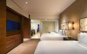 Voodi või voodid majutusasutuse Grand Hyatt Macau toas
