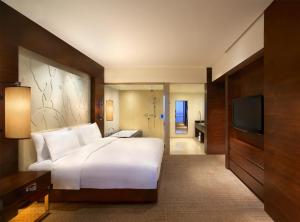 Voodi või voodid majutusasutuse Grand Hyatt Macau toas