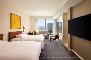 Voodi või voodid majutusasutuse Grand Hyatt Macau toas