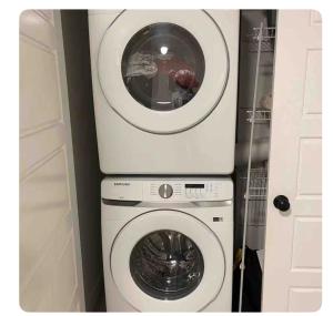 a washing machine and a dryer in a room at Bedroom in Southwest 2 in Edmonton