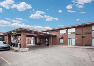 a large brick building with a parking lot at Comfort Inn West in Edmonton