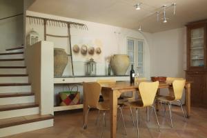 a dining room with a wooden table and chairs at Domaine de Villedese in Montlaur