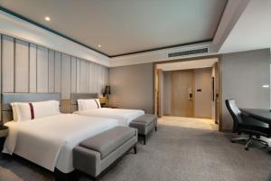 Postel nebo postele na pokoji v ubytování Rhombus Park Aura Chengdu Hotel