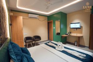 a hospital room with a bed and a desk at Luxe Inn in Brahmapur