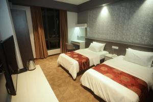 Postel nebo postele na pokoji v ubytování Star-Well hotel