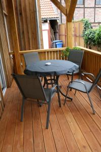a patio table and chairs on a deck at Apartments Altstadtoase in Wernigerode