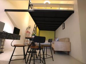 a room with chairs and a table and a ceiling at Kinta Valley Retreat in Ipoh