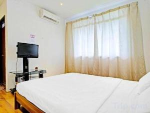 TV a/nebo společenská místnost v ubytování OYO 90597 Delightful Holiday Inn + 62 fotografií