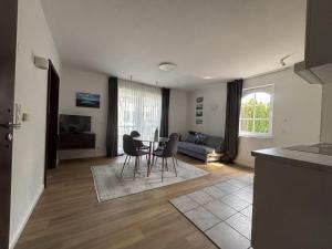a kitchen and living room with a table and chairs at Turmhotel Scharbeutz in Scharbeutz