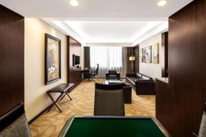 a living room with a pool table in a hotel room at Chongqing Sunshine Continental Grand Hotel in Chongqing