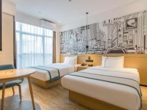 a hotel room with two beds and a drawing on the wall at City Comfort lnn Dayi High-speed Railway Station in Chengdu