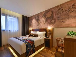 a hotel room with a bed with a teddy bear on it at James Joyce Coffetel Beijing Station in Beijing