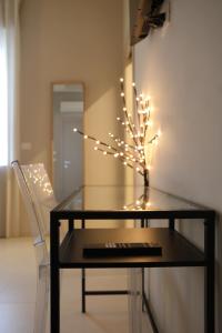 a glass table with a tree with lights on it at B&B Il Rifugio Urbano in Pescara +45 photos