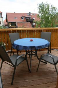 a blue table and two chairs on a deck at Apartments Altstadtoase in Wernigerode