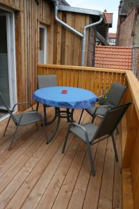 a patio with a table and chairs on a deck at Apartments Altstadtoase in Wernigerode