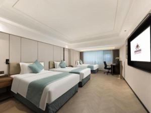 Ένα ή περισσότερα κρεβάτια σε δωμάτιο στο Xiamen Jin Rui Jia Tai Hotel +287 φωτογραφίες