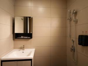 a bathroom with a sink and a shower with a mirror at Weiss Hotels Kepong Baru in Kuala Lumpur +144 photos