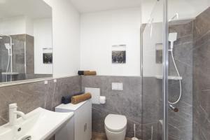 a bathroom with a shower and a toilet and a sink at Ferienquartier Forsthaus 2 in Bad Gottleuba +41 photos