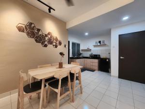 a kitchen and dining room with a wooden table and chairs at Malacca 3 bedroom Seri Serindit 07 in Malacca