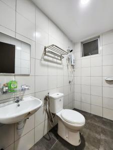 a white bathroom with a toilet and a sink at Malacca 3 bedroom Seri Serindit 07 in Melaka +39 photos