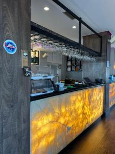 a kitchen with a counter in a restaurant at LA PLAYA - Seaside Guest Room in Durrës +25 photos
