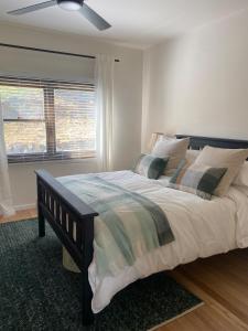 a bedroom with a large bed and a window at Livingstone-Omeo Hideaway in Omeo