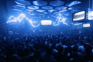 a crowd of people in a room with lights at Pacha Hotel in Ibiza Town