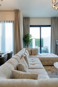 a living room with two large couches in a room at Nasma Luxury Stays - Opulent Family Escape in Marbella RAK in Ras al Khaimah