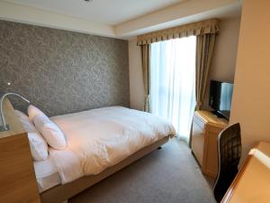 Postel nebo postele na pokoji v ubytování Utsunomiya Tobu Hotel Grande