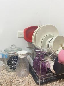 a dish rack with plates and other dishes on a counter at Mesatierra, Davao - Condo for Rent in Davao City +2 photos