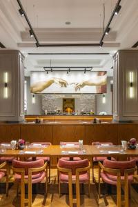 a dining room with tables and chairs and a fireplace at Hyatt Regency Baku in Baku
