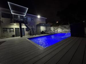 a swimming pool in a yard at night at The Mendel Boutique Residence in Harare