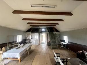 a large room with a bed and tables and chairs at Prästgården i Norra Rörum in Höör +1 photo