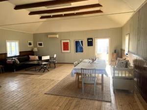 a large living room with a table and chairs at Prästgården i Norra Rörum in Höör