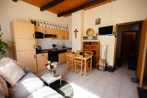 a living room and kitchen with a couch and a table at Kuća za odmor Mia in Stankovac