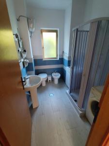 a bathroom with two toilets and a sink and a shower at Appartamenti vistAmare - La casa del vento in Vibonati +13 photos