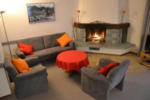 a living room with a couch and a fireplace at Arcula in Flims