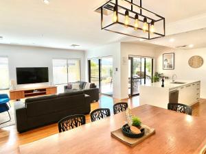 een woonkamer met een bank en een tafel bij Royal-Tee Retreat in Dunsborough