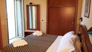 Postel nebo postele na pokoji v ubytování Hotel Grifone