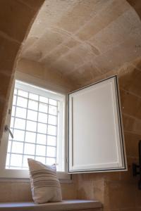 a window in a room with a pillow in front of it at Luna Inn in Matera