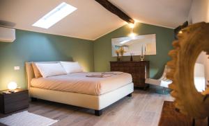 a bedroom with a large bed and a mirror at Dario Coos srl - Azienda vinicola in Sedilis