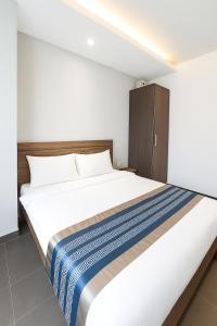 a bedroom with a large white bed and a cabinet at Hotel 1915 Chinatown Kuala Lumpur in Kuala Lumpur +13 photos