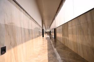 a hallway of a building with wooden walls at Hotel Shivganga Grand in Varanasi