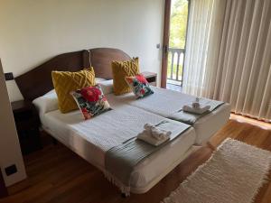 a bedroom with a bed with towels on it at Casona Asturiana Casa Delfa in Cervera