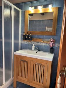 a bathroom with a sink and a mirror at Casona Asturiana Casa Delfa in Cervera +19 photos