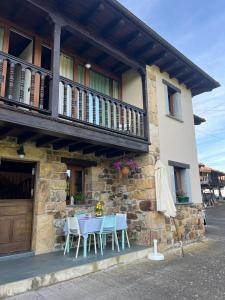 a table and chairs sitting outside of a building at Casona Asturiana Casa Delfa in Cervera